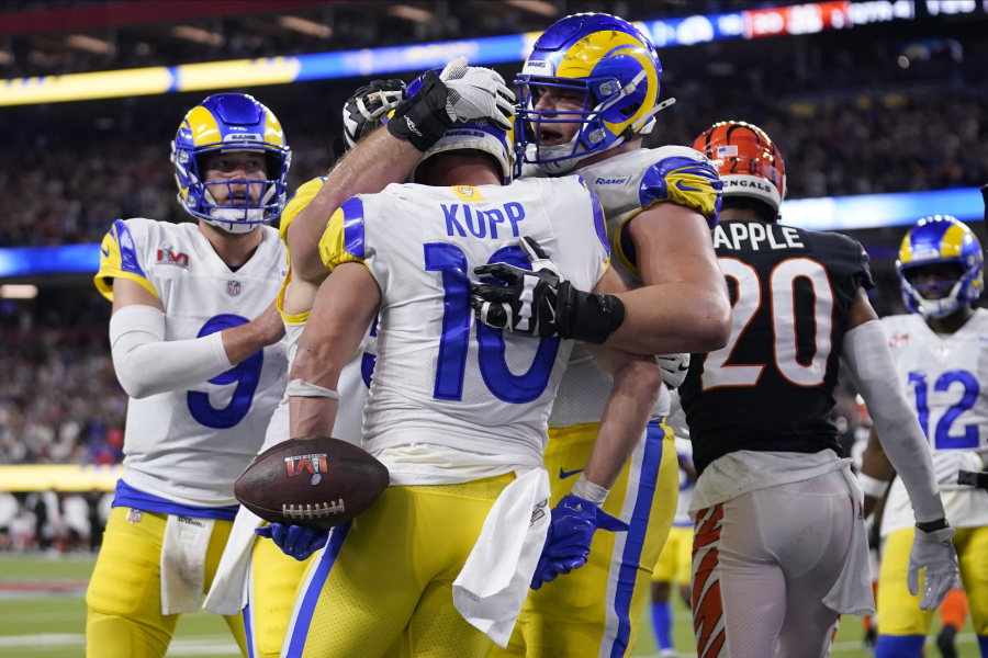 Los Angeles Rams wide receiver Cooper Kupp (10) is congratulated by teammates after scoring a touchdown against the Cincinnati Bengals during the second half of the NFL Super Bowl 56 football game Sunday, Feb. 13, 2022, in Inglewood, Calif.