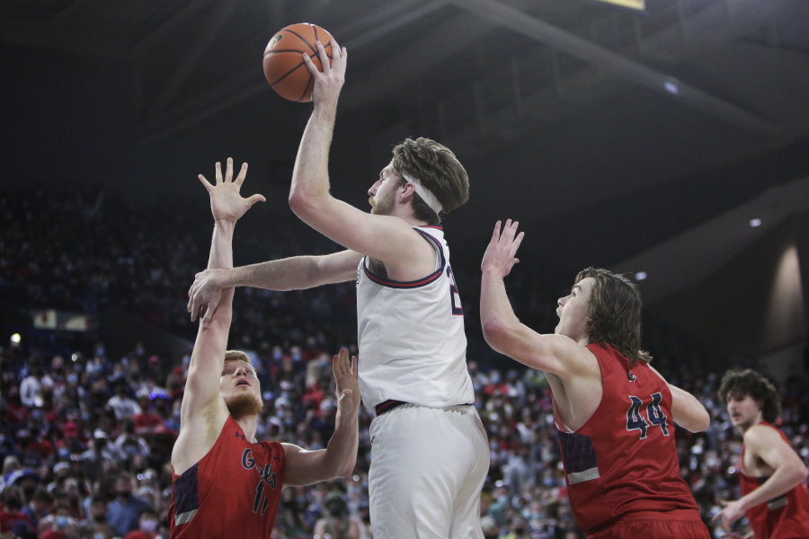 Gonzaga forward Drew Timme, center, shoots between Saint Mary's forward Matthias Tass, left, and guard Alex Ducas during the first half of an NCAA college basketball game Saturday, Feb. 12, 2022, in Spokane, Wash.