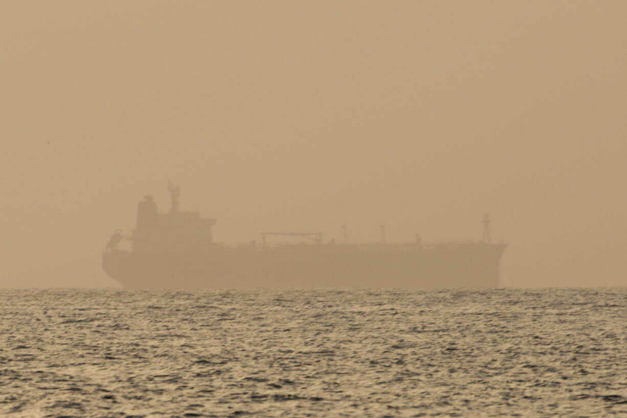 FILE - An oil tanker is moored off Fujairah, United Arab Emirates, Wednesday, Aug. 4, 2021. Technology to hide a ship's location previously available only to the world's militaries is spreading fast through the global maritime industry as governments from Iran to Venezuela -- and the rogue shipping companies they depend on to move their petroleum products -- look for stealthier ways to circumvent U.S. sanctions.