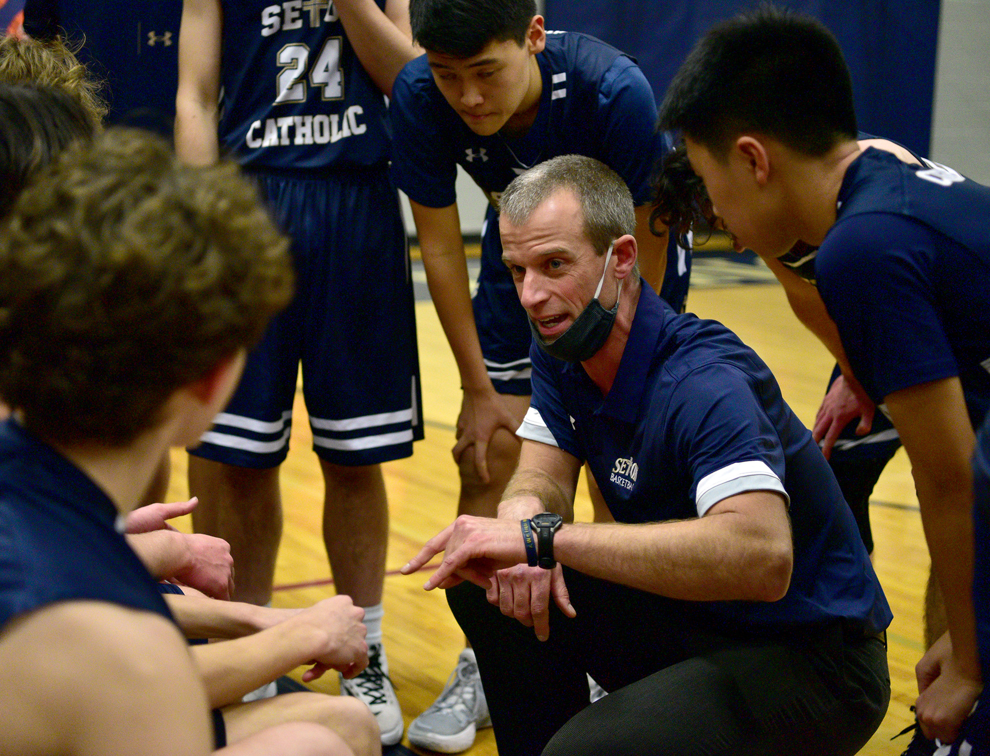 Seton Catholic boys basketball coach Aaron Jenniges talks to the team between quarters Tuesday, Feb. 1, 2022, during the Cougars’ 32-23 loss to the Knights at King’s Way Christian High School.
