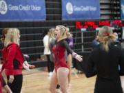 Camas senior Peyton Cody reacts with her coach Carol Willson after her routine on the bars, on which she placed third, at the 4A state gymnastics meet at Sammamish High School in Bellevue on Saturday, Feb. 26, 2022.