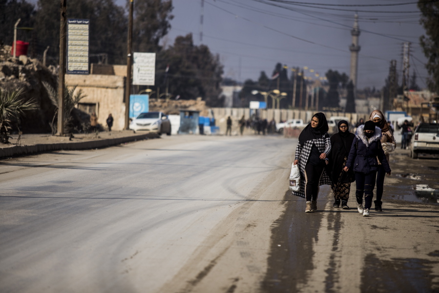 Civilians return to the city after fighting subsideds in Hassakeh, Syria, Sunday, Jan. 30, 2022. The Islamic State group's Jan. 20 attack on the prison in Hassakeh was the biggest military operation by the extremist group since the fall of their self-declared caliphate in 2019.