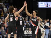 Portland Trail Blazers guards CJ Elleby (16) and Anfernee Simons (1) high five in the second half of an NBA basketball game against the Memphis Grizzlies Wednesday, Feb. 16, 2022, in Memphis, Tenn.