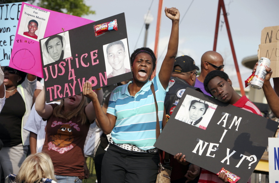In this March 22, 2012 file photo, protestors, Lakesha Hall, of Sanford, center, and her son, Calvin Simms, right, participate in a rally for Trayvon Martin, the black teenager who was fatally shot by George Zimmerman, a neighborhood watch captain in Sanford, Fla. The killing of Trayvon Martin at the hands of a stranger still reverberates 10 years later -- in protest, in partisanship, in racial reckoning and reactionary response, in social justice and social media.