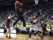 Southern California guard Ethan Anderson (20) pulls down a rebound against Oregon during the first half of an NCAA college basketball game in Eugene, Ore., Saturday, Feb. 26, 2022.