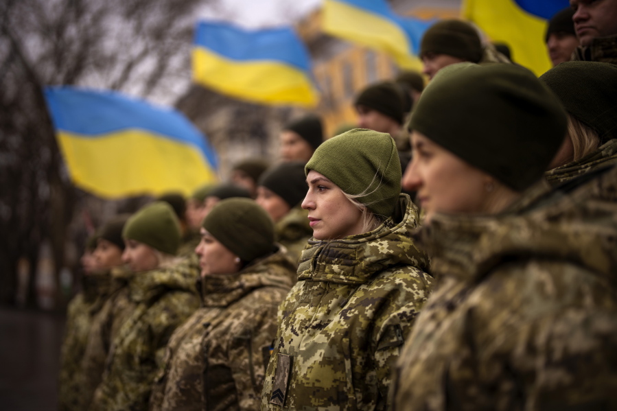 Ukrainian Army soldiers pose for a photo as they gather to celebrate a Day of Unity in Odessa, Ukraine, Wednesday, Feb. 16, 2022. As Western officials warned a Russian invasion could happen as early as today, the Ukrainian President Zelenskyy called for a Day of Unity, with Ukrainians encouraged to raise Ukrainian flags across the country.