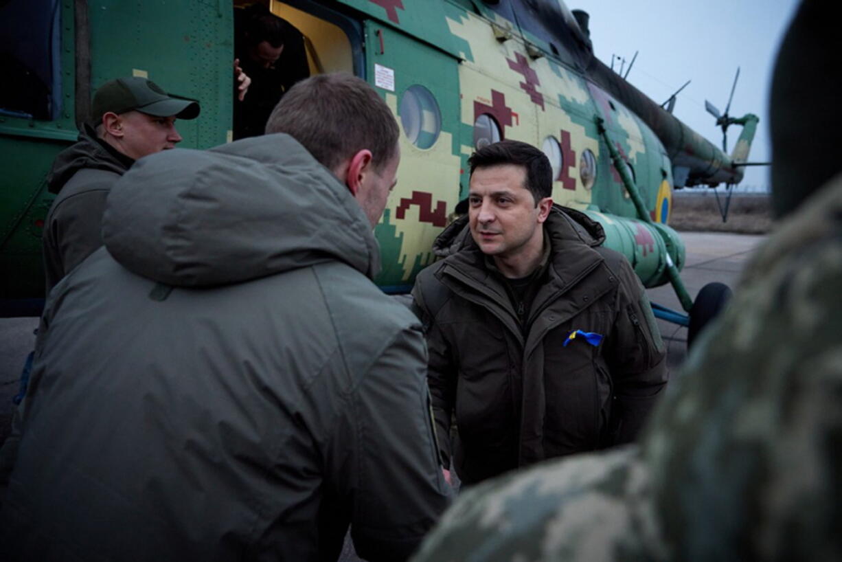 In this handout photo provided by the Ukrainian Presidential Press Office, Ukrainian President Volodymyr Zelenskyy greets Ukrainian coast guards in Mariupol, Donetsk region, eastern Ukraine, Thursday, Feb. 17, 2022. U.S. Secretary of State Antony Blinken told ABC News that Russian President Vladimir Putin "can pull the trigger. He can pull it today. He can pull it tomorrow. He can pull it next week. The forces are there if he wants to renew aggression against Ukraine." NATO Secretary-General Jens Stoltenberg and Ukrainian President Volodymyr Zelenskyy also dismissed the Russian claims.