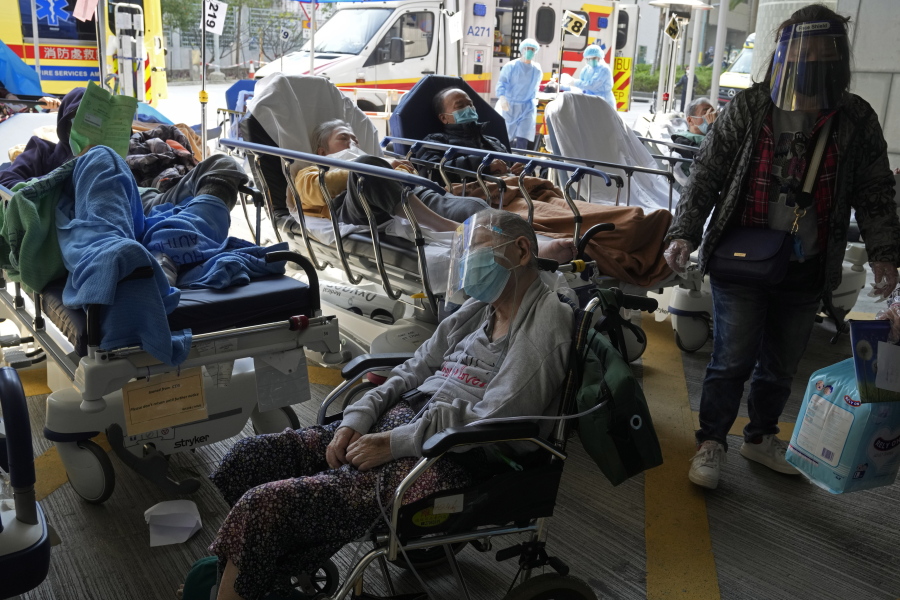 Patients wait at a temporary treatment area outside Caritas Medical Centre in Hong Kong, Saturday, Feb. 26, 2022. For two years, Hong Kong successfully insulated most of its residents from COVID-19 and often went months without a single locally spread case. Then the omicron variant showed up. The fast-spreading mutation breached Hong Kong's defenses and has been spreading rapidly through one of the world's most densely populated places.
