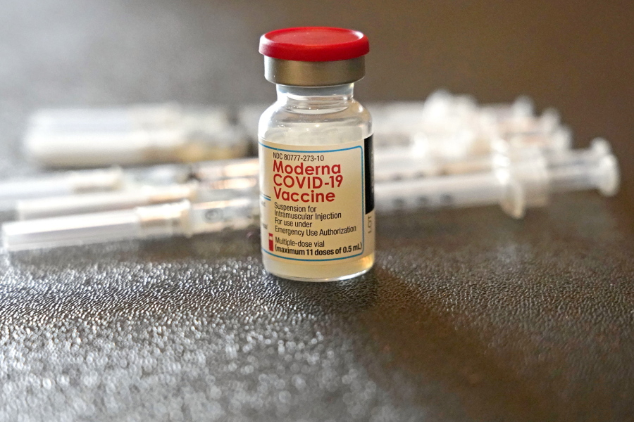 FILE - A vial filled with the Moderna COVID-19 vaccine rests by syringes waiting to be loaded by nurses from the Jackson-Hinds Comprehensive Health Center, at a vaccination station next to Jackson State University in Jackson, Miss., Tuesday, Dec. 7, 2021.  The vaccination drive against COVID-19 in the U.S. is grinding to a halt, and lagging demand is especially stark in conservative corners of the country where many people weren't interested in the shots in the first place. (AP Photo/Rogelio V.