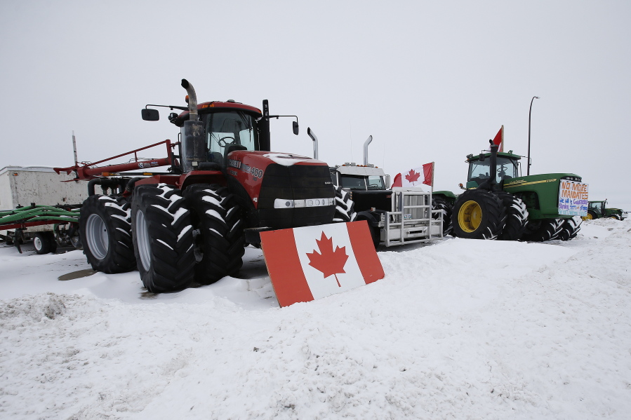 People block highway 75 with heavy trucks and farm equipment and access to the Canada-United States border crossing at Emerson, Manitoba, Thursday, Feb. 10, 2022. The blockade was set up to rally against provincial and federal COVID-19 vaccine mandates and in support of Ottawa protestors.