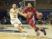 Washington State guard Michael Flowers (12) dribbles while defended by California guard Jordan Shepherd (31) during the first half in an NCAA college basketball game in Berkeley, Calif., Saturday, Feb. 5, 2022.