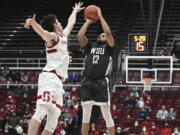 Stanford forward Maxime Raynaud (42) defends against Washington State guard Michael Flowers (12) during the second half of an NCAA college basketball game in Stanford, Calif., Thursday, Feb. 3, 2022.