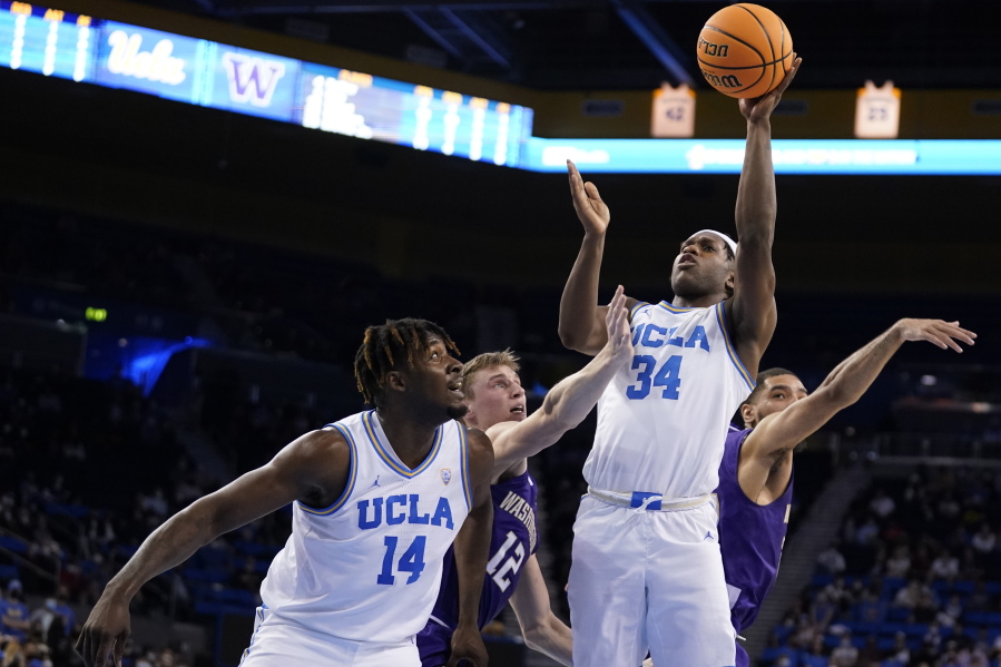 UCLA guard David Singleton (34) scores against Washington during the second half of an NCAA college basketball game Saturday, Feb. 19, 2022, in Los Angeles.