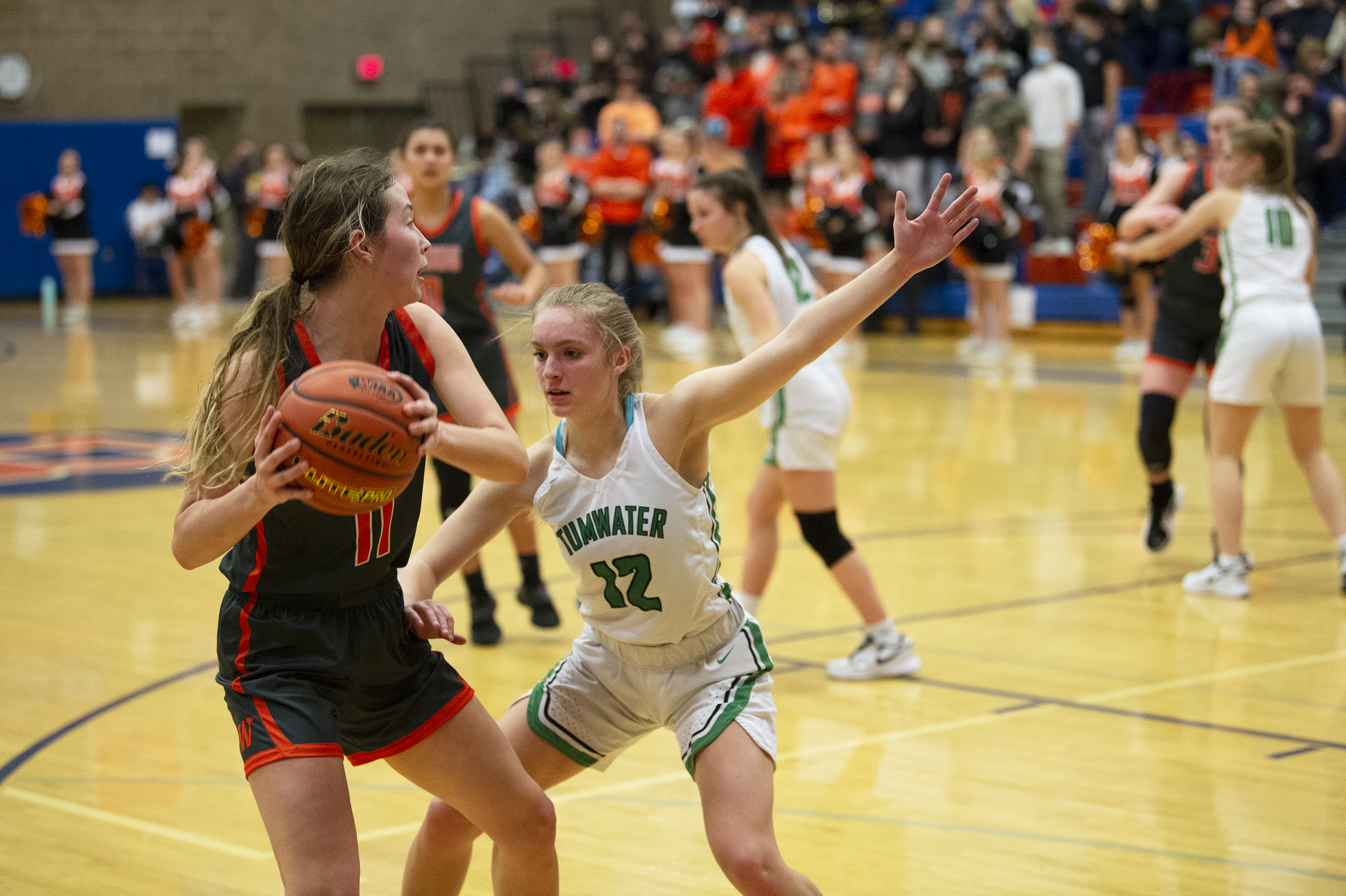 Washougal's Samantha Mederos is defended by Tumwater's Aubrey Amendala during the 2A girls basketball district semifinal on Monday in Ridgefield (Tim Martinez/The Columbian)
