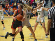 Washougal's Jaiden Bea bobbles the ball while being defended by Tumwater's Natalie Sumrok during the 2A girls basketball district semifinal at Ridgefield High School (Tim Martinez/The Columbian)