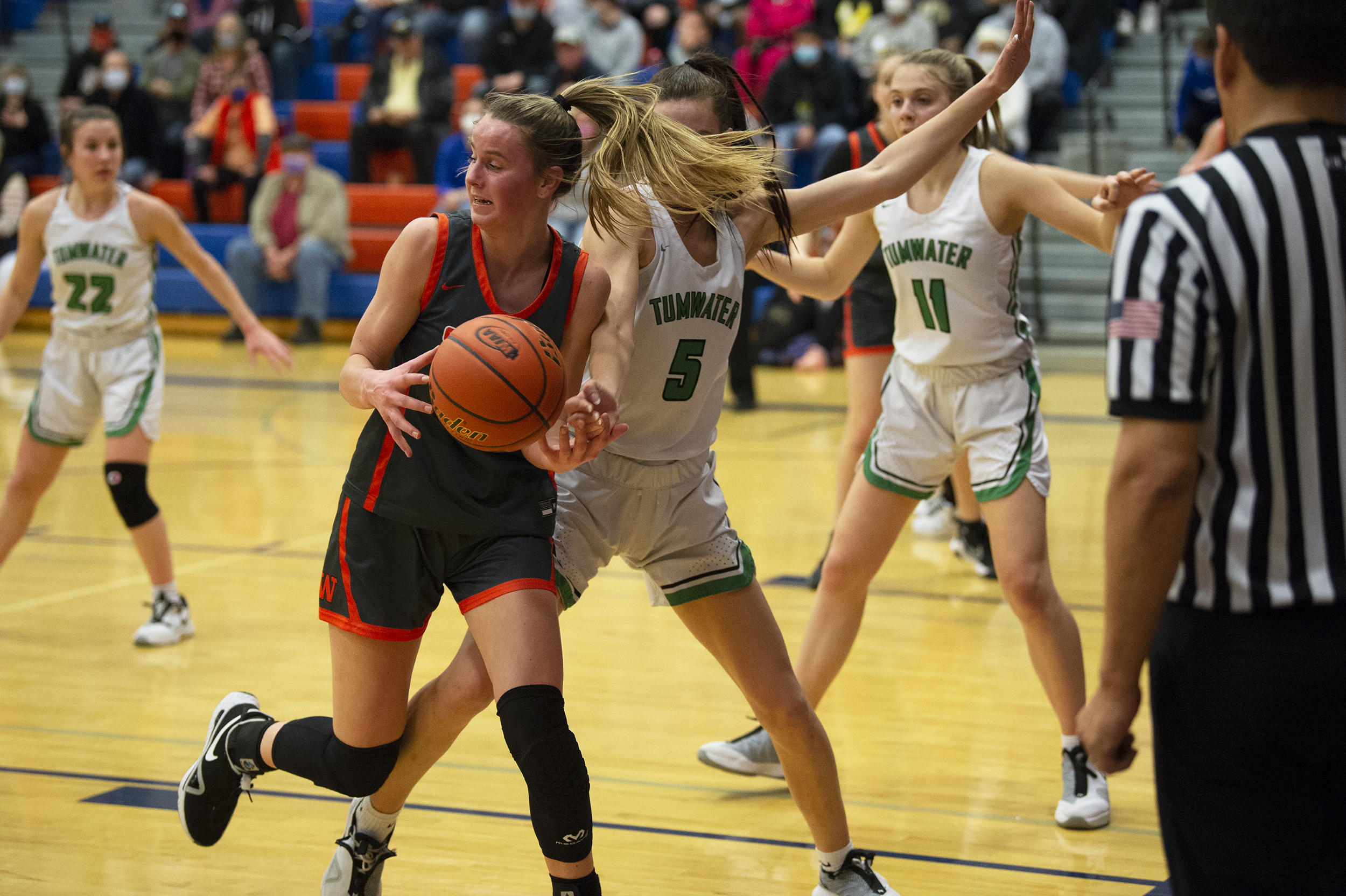 Washougal's Jaiden Bea bobbles the ball while being defended by Tumwater's Natalie Sumrok during the 2A girls basketball district semifinal at Ridgefield High School (Tim Martinez/The Columbian)