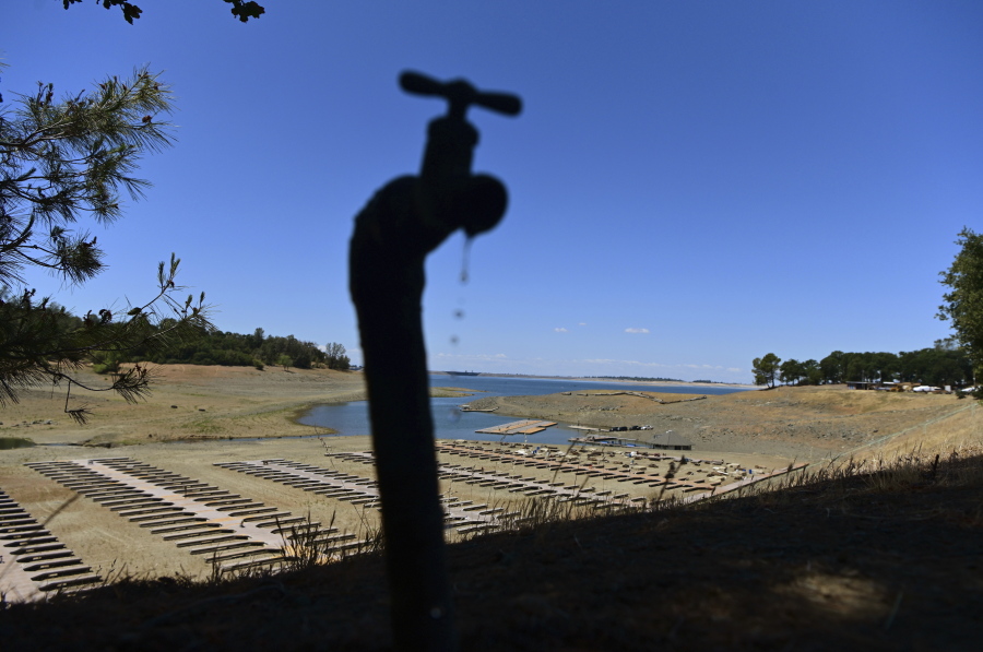 FILE - Water drips from a faucet near boat docks sitting on dry land at the Browns Ravine Cove area of drought-stricken Folsom Lake in Folsom, Calif., on May 22, 2022. The American West's megadrought deepened so much last year that it is now the driest it has been in at least 1200 years and a worst-case scenario playing out live, a new study finds.
