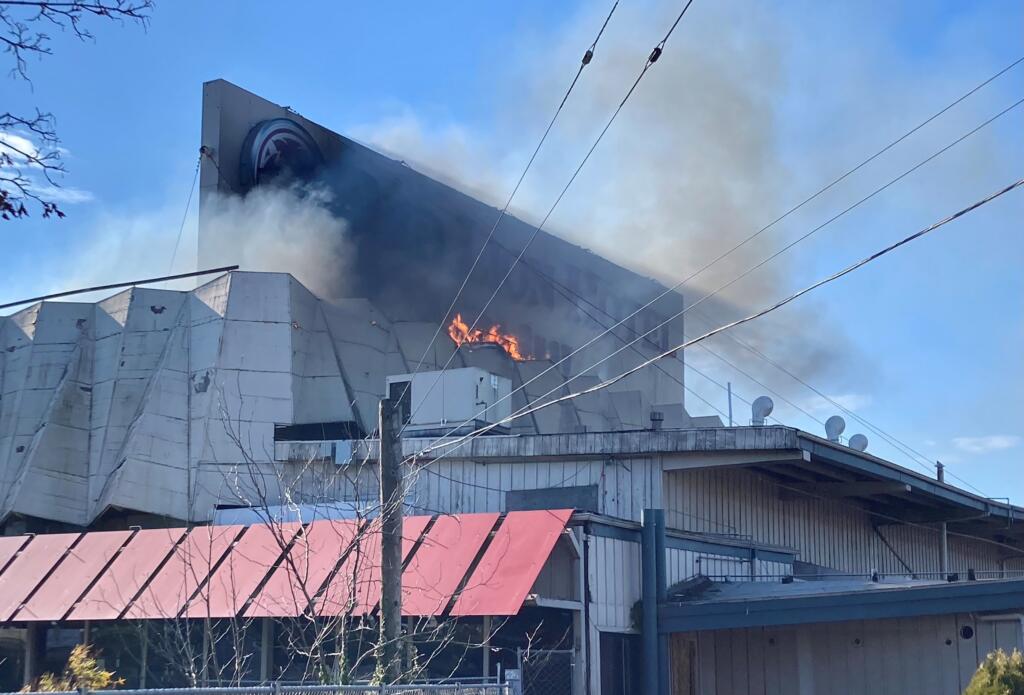 A roof fire burns in the former Red Lion at the Quay on Tuesday afternoon. The building was undergoing demolition work when the three-alarm fire began.