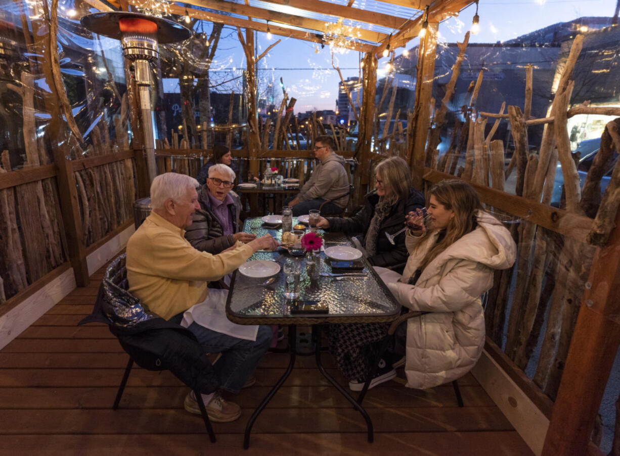 Clockwise from left at the closest table: Bill and Barbara Seeba, of Vancouver, and Melissa and Madison Soler, of Portland, enjoy an evening on the heated patio of Elements Restaurant on Friday, Jan. 22, 2021, on Main Street in downtown Vancouver.