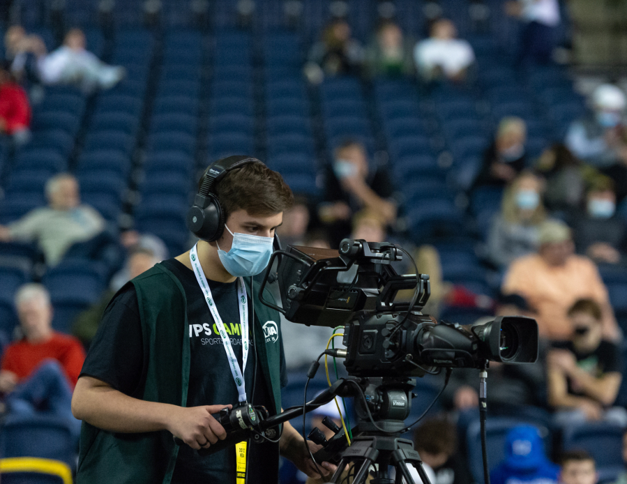 Columbia River High School junior Ethan Reyes operates a courtside camera for VPS GameTime in a 4A State Boys Basketball semifinal on  Friday, March 4, 2022, at the Tacoma Dome.