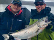 Guide Bill Monroe, (left), with a client and a nice spring Chinook caught in the Columbia River during last year's spring salmon fishery. Projections for the spring Chinook run are up this year, and anglers should see better fishing than the past few years.
