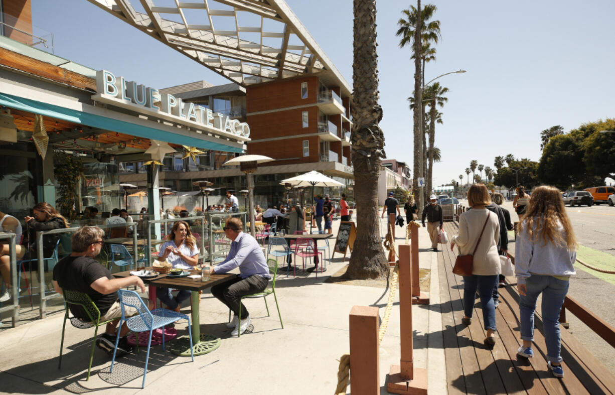 People dine at Blue Plate Taco in Santa Monica, Calif., as people take advantage of the warm weather during the COVID-19 spring break in Southern California on March 29, 2021.