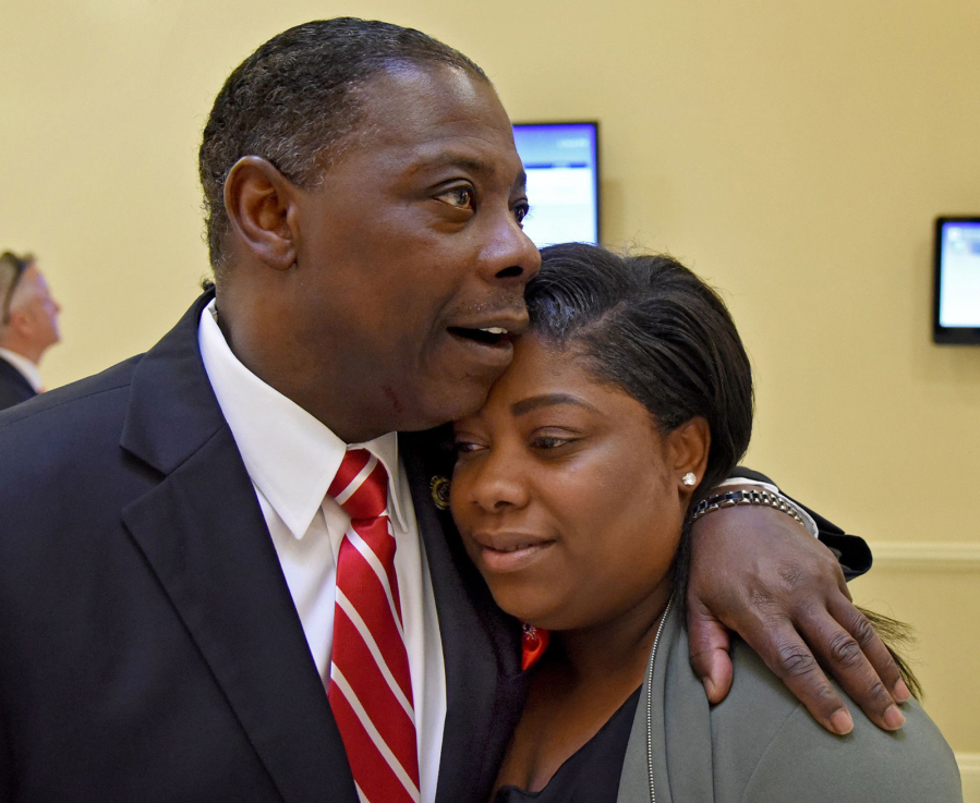 Del. Talmadge Branch comforts his daughter, Chanel Branch, before they spoke in support of a bill in March 2018. They shared personal testimony before the House Appropriation Committee about their ongoing grief after Chanel's son was killed in 2017.