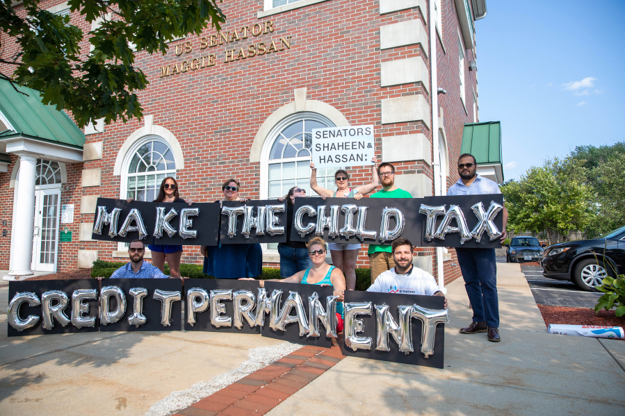 New Hampshire parents and other supporters gather outside of Senator Hassan's Manchester office to thank her for child tax credit payments and demand they be made permanent on Sept. 14, 2021, in Manchester, New Hampshire.