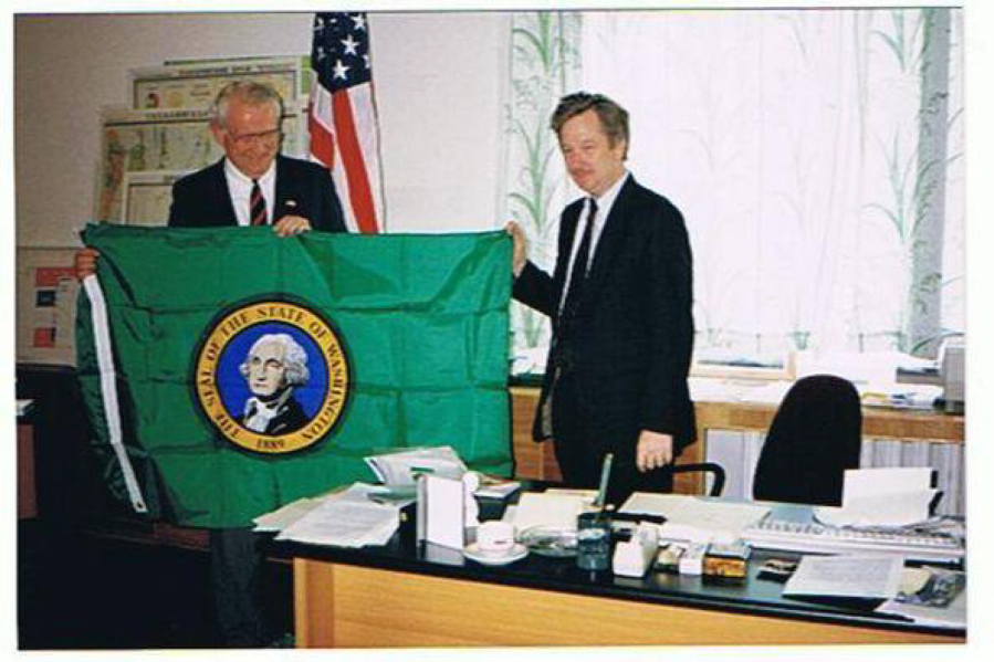 Former Washington Secretary of State Ralph Munro holds up a state flag with Randall Lecocq, U.S. consul general to Russia's eastern territory, during a trade mission to Vladivostok, Russia, in 1993.