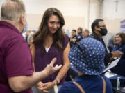 Henry Pio of Hazel Dell, from left, talks with Rep. Jaime Herrera Beutler as she greets his stepdaughter, Geovanna Alarcon, who is looking for employment, during a job fair at the Clark County Event Center at the Fairgrounds on Aug.