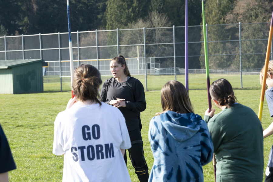 Four-time Olympian and Skyview graduate Kara Winger talks to members of the Skyview track and field team before going throw a practice session with Skyview javelin throwers on Friday, March 11, 2022 (Tim Martinez/The Columbian)