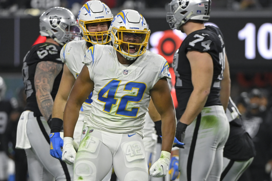 Los Angeles Chargers outside linebacker Uchenna Nwosu (42) reacts after a play against the Las Vegas Raiders during the first half of an NFL football game, Sunday, Jan. 9, 2022, in Las Vegas.