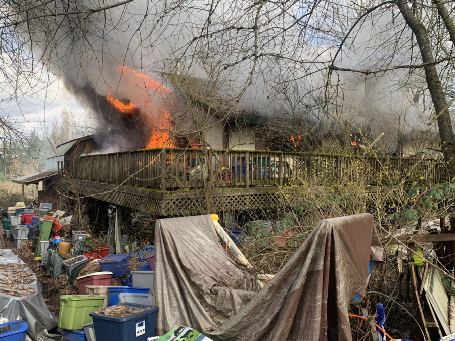A house burns Wednesday afternoon in the Cherry Grove area west of Battle Ground. The adult residents were displaced, and the house was a total loss.