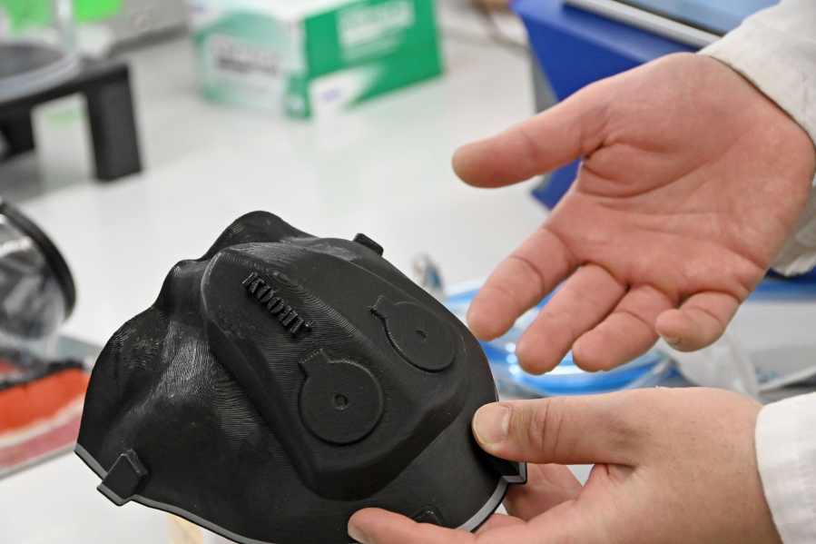 Kevin Aroom, research engineer at the University of Maryland Robert E. Fischell Institute for Biomedical Devices, holds a 3D-printed custom conformal mold for a respirator based on a scan of his face to fashion a custom-fitted mask, on March 3, 2022.