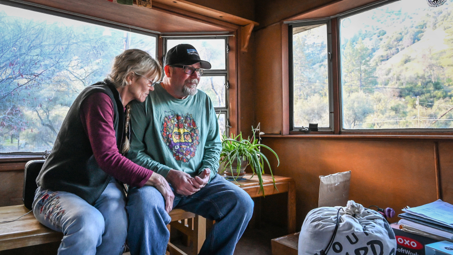 Longtime El Portal Trailer Park residents Neal and Nancy Dawson take a moment in their front room to take in the panoramic views of the surrounding canyon hills before moving out for good on March 13, 2022.