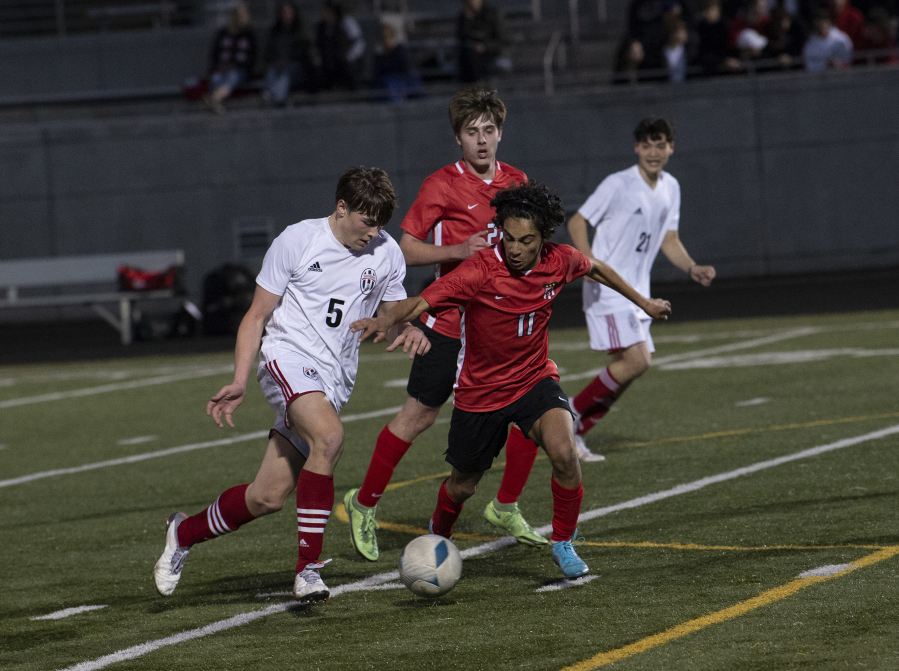 Union's Hayden Sadewasser (5) battles Camas' Shiven Friedeman (11) for the ball during Union's 1-0 win over the Papermakers on Thursday at Doc Harris Stadium.
