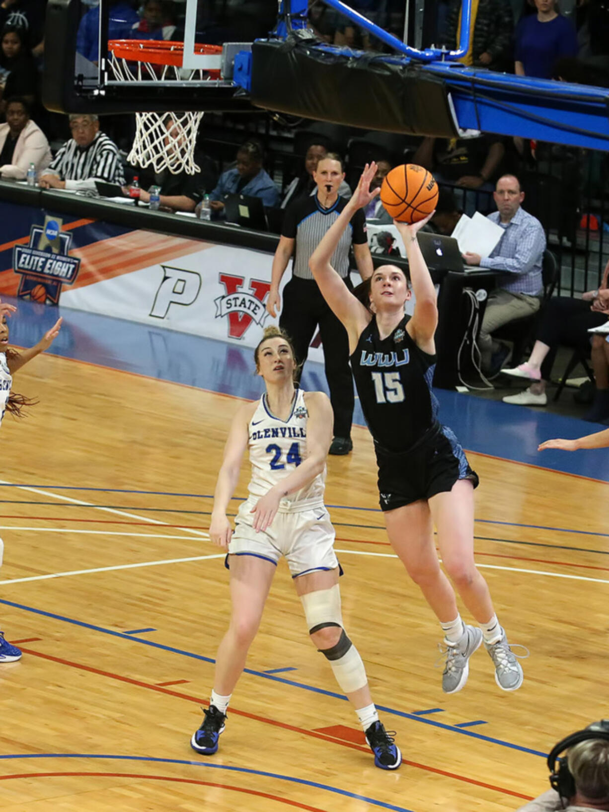 Western Washington?s Brooke Walling (15) goes past Glenville State?s Abby Stoller for two of her career-high 27 points during the NCAA Division II women?s championship game Friday at Birmingham, Ala.