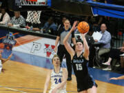 Western Washington?s Brooke Walling (15) goes past Glenville State?s Abby Stoller for two of her career-high 27 points during the NCAA Division II women?s championship game Friday at Birmingham, Ala.