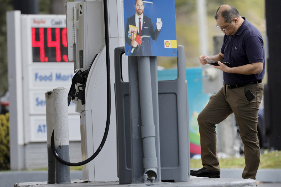 A man uses a credit card to fill up at a Shell station in Fort Lauderdale, Florida, on Thursday, March 10, 2022.
