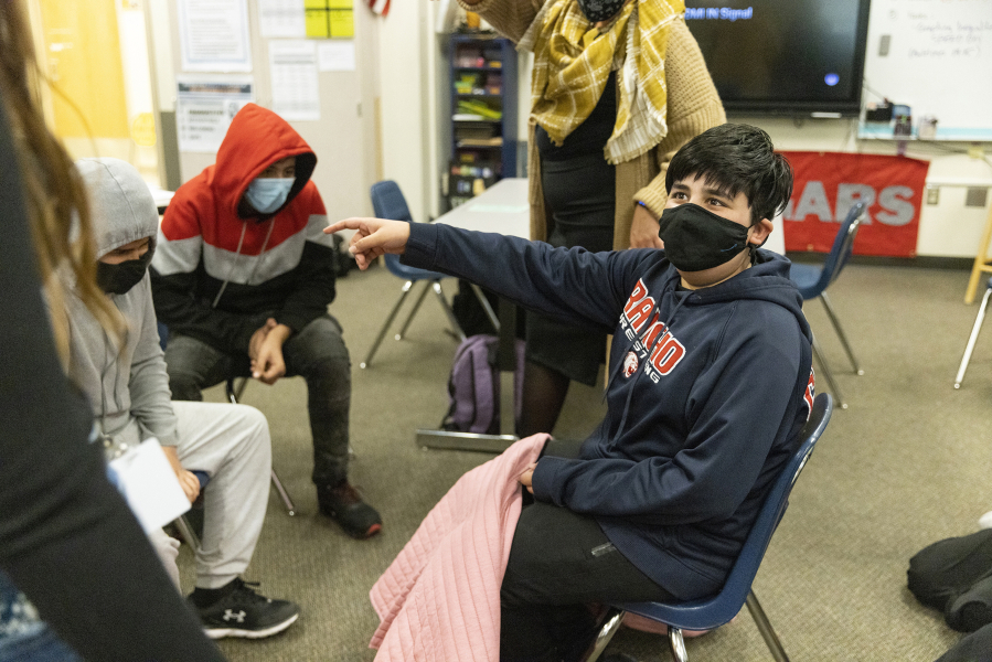 Abdullah plays a game with students at the after-school program for refugee children, run by the resettlement agency World Relief, at Mill Creek Middle School in Kent, Washington, on Tuesday, Feb. 15, 2022.