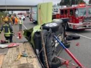 The car a 72-year-old Vancouver woman was extricated from after she crashed into an Oregon woman changing lanes Wednesday morning southbound on Interstate 5. The Vancouver woman's Kia Soul slid into a flatbed trailer that road crews were using on the shoulder of the freeway.