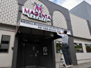 Volunteer Peter Wonderly spells out a message in May 2020 after Magenta came up with the idea of renting out its Main Street marquee to generate a little income for the theater during a lengthy coronavirus pause.