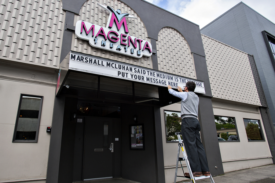 Volunteer Peter Wonderly spells out a message in May 2020 after Magenta came up with the idea of renting out its Main Street marquee to generate a little income for the theater during a lengthy coronavirus pause.