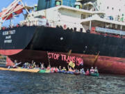 "Kayaktivists" interfere with river traffic at the Port of Vancouver to block shipments of oil pipeline equipment.