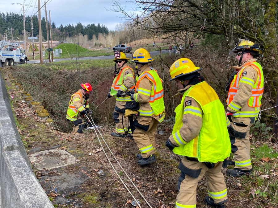 Clark County Fire District 6 crews rescue a man Wednesday afternoon whose vehicle veered off Highway 99 in Salmon Creek, crashed into a power pole and fell 25 feet into a gully. A sheriff's office spokesman said there's no indication the driver was impaired or speeding.