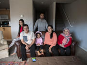 Members of the Azizpour family — refugees from Kabul, Afghanistan — are restarting their lives in Clark County. “Every morning is a surprise,” said Maryam Azizpour, 30, second from right. With Maryam at the family’s Hazel Dell rental are her daughter Marwa Azizpour, 10, far left; father Mohammad Ismail Rezayee; daughter Murwarid Azizpour, 6; brother Sajad Ibrahimi; and mother Sediqa Rustami.