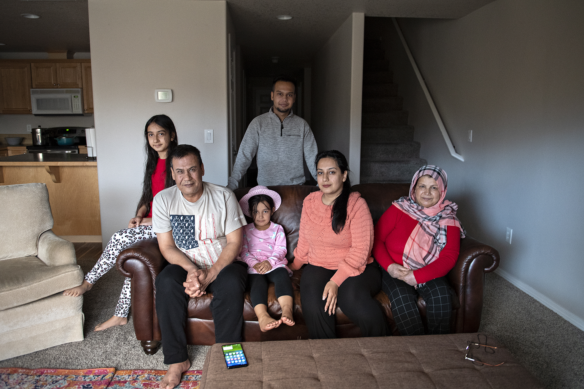Members of the Azizpour family — refugees from Kabul, Afghanistan — are restarting their lives in Clark County. “Every morning is a surprise,” said Maryam Azizpour, 30, second from right. With Maryam at the family’s Hazel Dell rental are her daughter Marwa Azizpour, 10, far left; father Mohammad Ismail Rezayee; daughter Murwarid Azizpour, 6; brother Sajad Ibrahimi; and mother Sediqa Rustami.