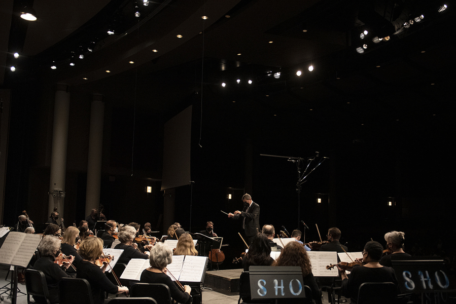 Maestro Salvador Brotons, facing, leads the Vancouver Symphony Orchestra during a concert at Skyview High School on Friday.