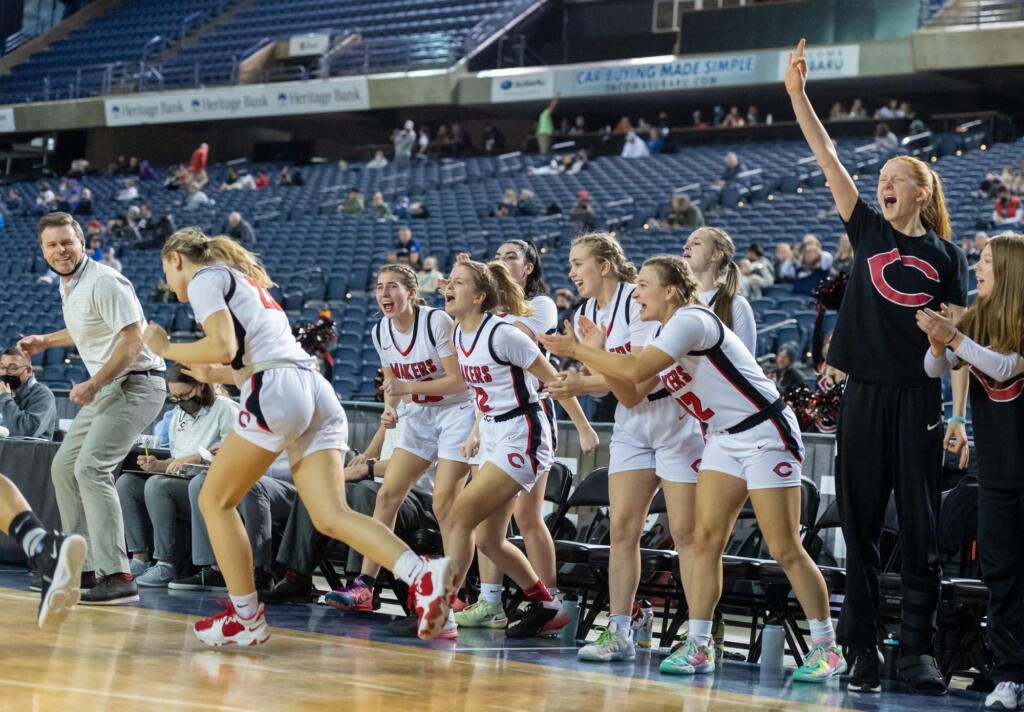 The Camas bench celebrates Riley Sanz's made 3-pointer in a 4A State Girls Basketball consolation game on  Friday, March 4, 2022, at the Tacoma Dome.