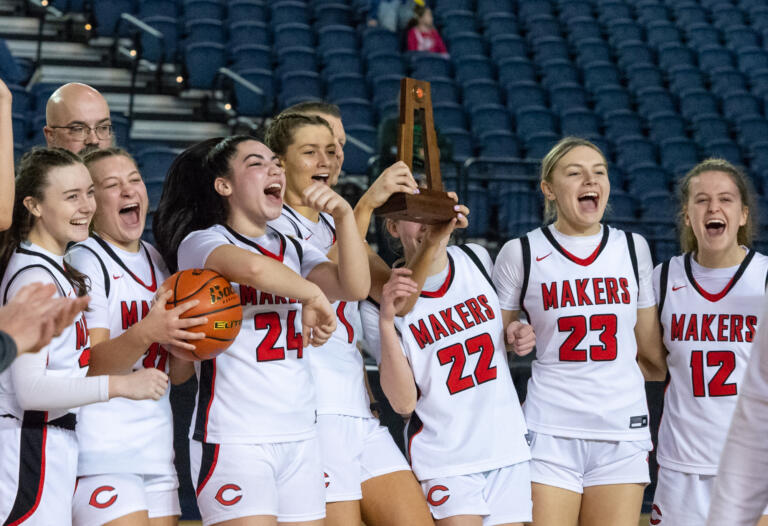 Camas celebrates a program-first state trophy in a 4A State Girls Basketball fourth-place game on  Saturday, March 5, 2022, at the Tacoma Dome.